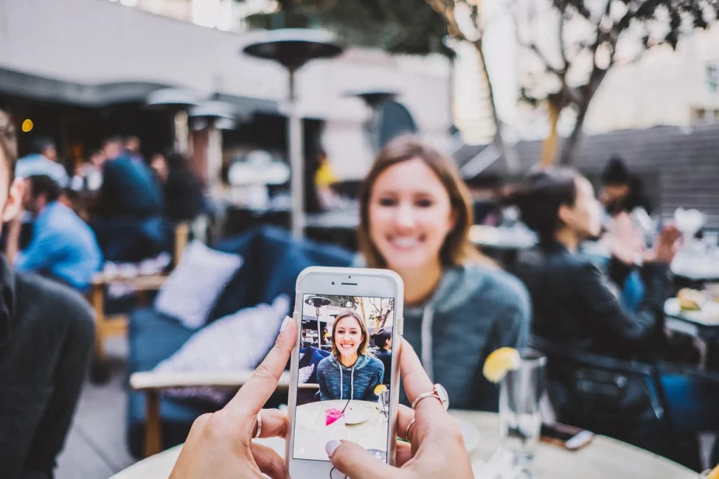 Dona de ateliê de cerâmica fotografa uma caneca com o celular para cadastrar o produto na loja virtual